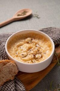 French Onion Soup with golden melted cheese on top, served in an oven-safe bowl.