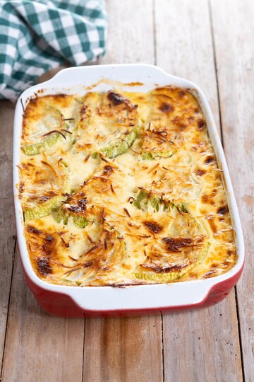 A serving of Garlicky Shrimp Alfredo Bake with golden melted cheese and fresh parsley garnish.