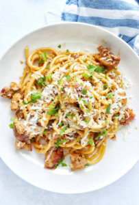 White Wine Chicken Pasta in a creamy sauce, garnished with parsley, served in a white bowl